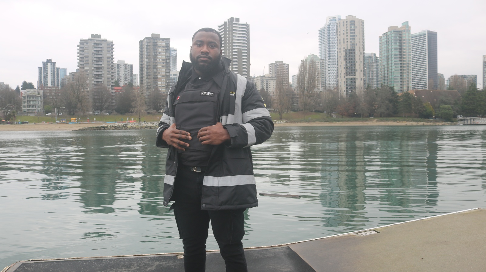 professional-security-guard-on-dock-with-city-skyline-background | GPS: 49.180807, -122.871044