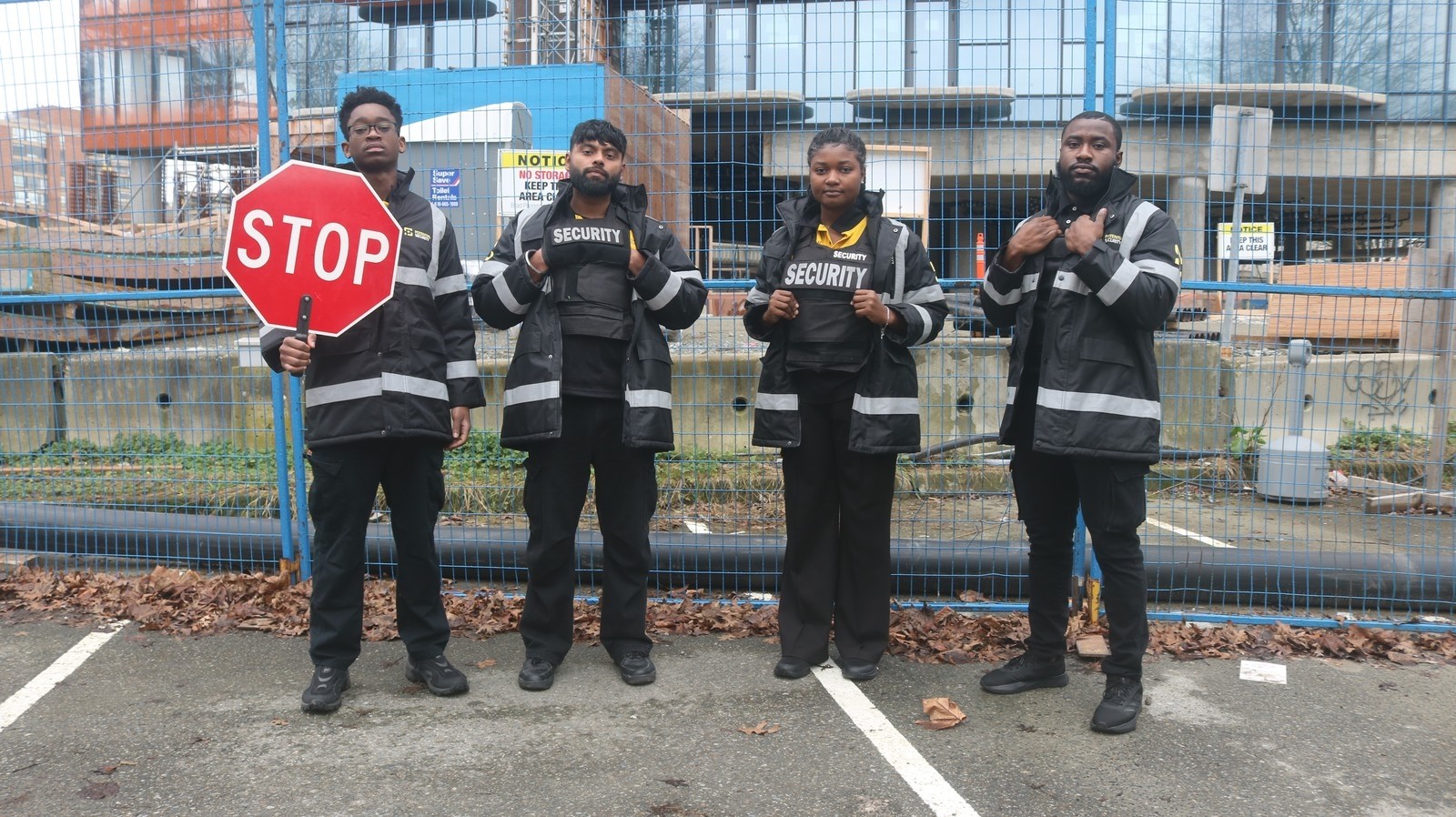 security-team-in-langley-holding-stop-sign-at-construction-site