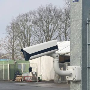 Security camera hangs on the fence